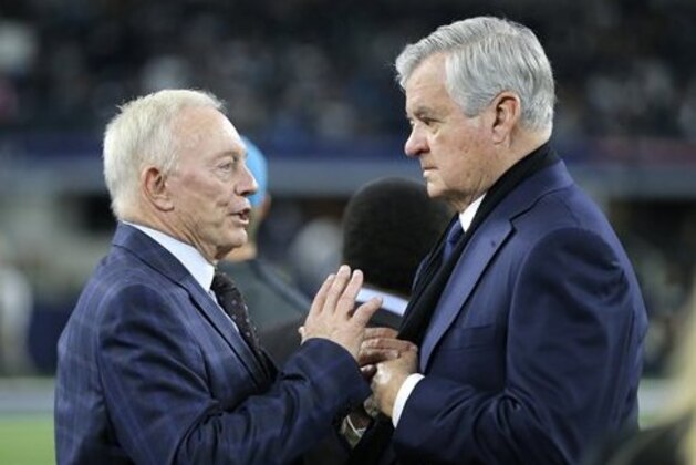 Dallas Cowboys team owner Jerry Jones, left, and Jerry Richardson, principal owner of the Carolina Panthers talk on the field before an NFL football game Thursday, Nov. 26, 2015, in Arlington, Texas. (AP Photo/Brandon Wade)