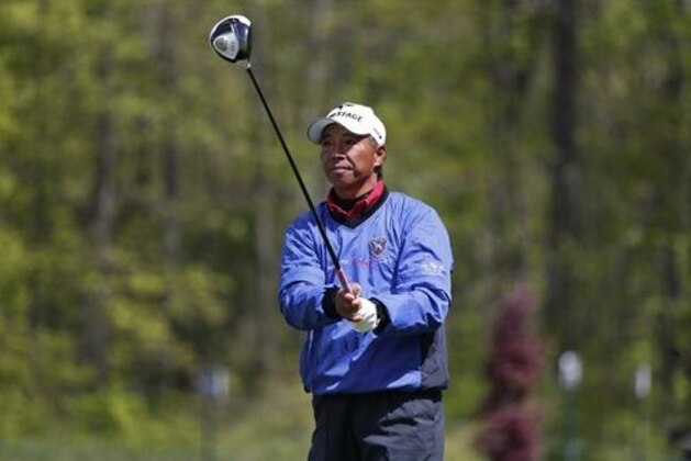 Kohki Idoki, of Japan, watches his tee shot on the 12th hole in the first round of the 75th Senior PGA Championship golf tournament at the Harbor Shores Golf Club during a news conference in Benton Harbor, Mich., Thursday, May 22, 2014.  (AP Photo/Paul Sancya)