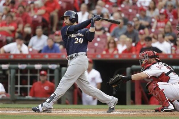Milwaukee Brewers' Jonathan Lucroy watches his RBI sacrifice fly off Cincinnati Reds starting pitcher Anthony DeSclafani during the first inning of a baseball game, Friday, July 15, 2016, in Cincinnati. (AP Photo/John Minchillo)