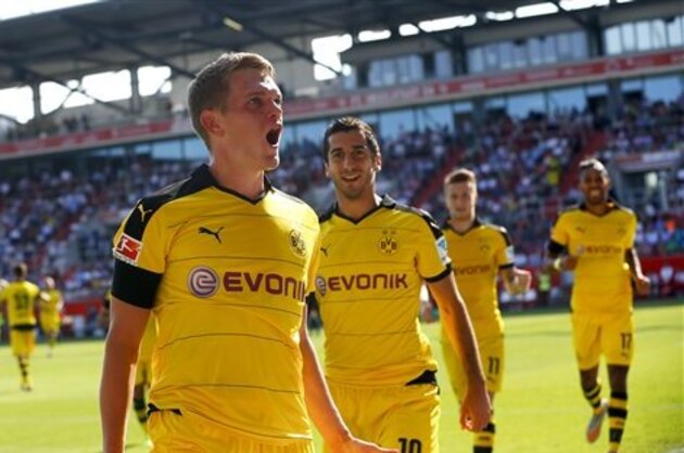 Dortmund's Matthias Ginter celebrates after scoring the opening goal during the German Bundesliga soccer match between FC Ingolstadt 04 and Borussia Dortmund in Ingolstadt, Germany, Sunday, Aug. 23, 2015. (AP Photo/Matthias Schrader)
