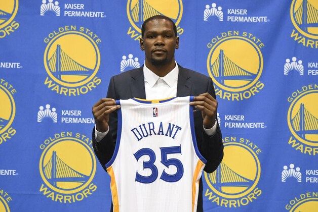 Jul 7, 2016; Oakland, CA, USA; Kevin Durant poses for a photo with his jersey during a press conference after signing with the Golden State Warriors at the Warriors Practice Facility. Mandatory Credit: Kyle Terada-USA TODAY Sports