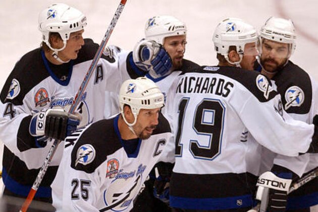 Tampa Bay Lightning's Brad Richards (19) celebrates his first period goal with teammates Vincent Lecavalier (4), Dave Andreychuk (25), Martin St. Louis, center rear, and Dan Boyle, right, in  game four of  the Stanley Cup finals,  Monday, May 31, 2004 in Calgary.(AP Photo/Gene J. Puskar)