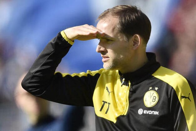 Dortmund head coach Thomas Tuchel watches the pitch against the sun during the German Bundesliga soccer match between Borussia Dortmund and Hamburger SV in Dortmund, Germany, Sunday, April 17, 2016. (AP Photo/Martin Meissner)