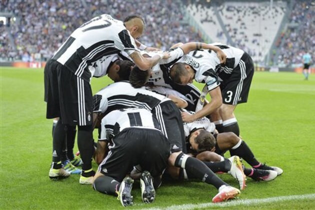 Juventus' Patrice Evra celebrates with teammates after scoring during a Serie A soccer match between Juventus and Sampdoria, at the Turin Juventus stadium Saturday, May 14, 2016. (Alessandro Di Marco/ANSA via AP)