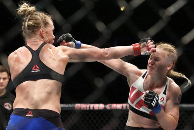 Holly Holm, left, fights Valentina Shevchenko during women's bantamweight mixed martial arts bout in Chicago, Saturday, July 23, 2016. (AP Photo/Nam Y. Huh)