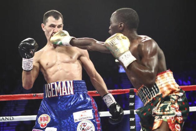 Viktor Postol, left, is hit by Terence Crawford during WBC-WBO junior welterweight unification title bout in Las Vegas on Saturday, July 23, 2016. (AP Photo/Chase Stevens)
