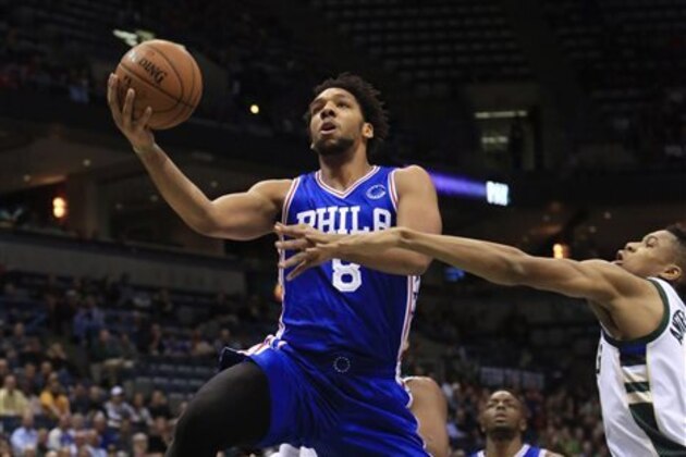 Philadelphia 76ers center Jahlil Okafor, left, goes up for a basket against Milwaukee Bucks forward Giannis Antetokounmpo, right, during the first half of an NBA basketball game Wednesday, Nov. 4, 2015, in Milwaukee. (AP Photo/Darren Hauck)