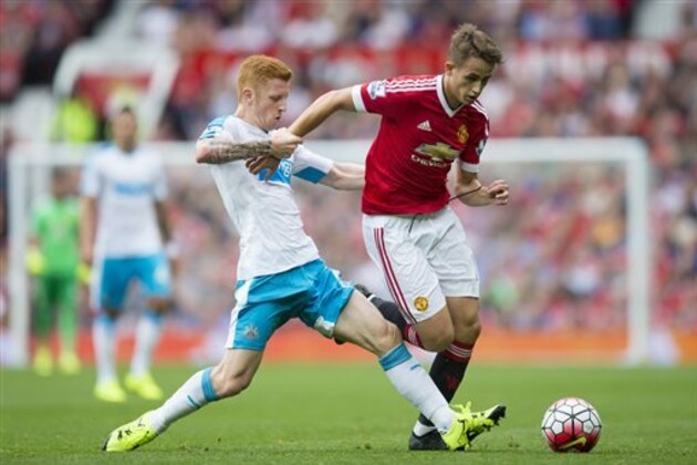 Manchester United's Adnan Januzaj, right, fights for the ball against Newcastle's Jack Colback during the English Premier League soccer match between Manchester United and Newcastle at Old Trafford Stadium, Manchester, England, Saturday, Aug. 22, 2015. (AP Photo/Jon Super)