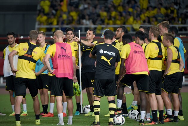 Dortmund's head coach Thomas Tuchel (C) looks at his watch as he takes part in a training session with teammates ahead of the 2016 International Champions Cup football match between Manchester United and Dortmund in Shanghai on July 21, 2016. / AFP / WANG ZHAO        (Photo credit should read WANG ZHAO/AFP/Getty Images)