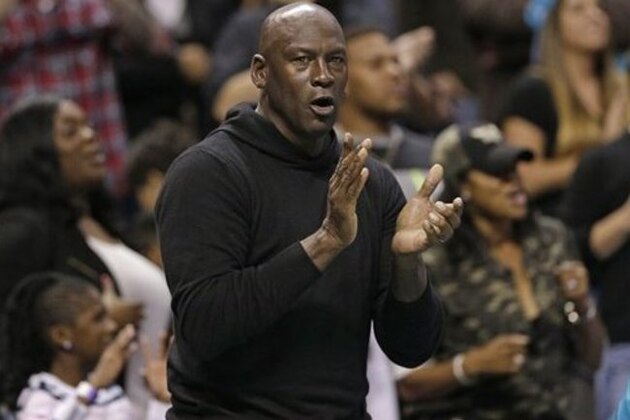 Charlotte Hornets owner Michael Jordan celebrates in the second half of an NBA basketball game against the Washington Wizards  in Charlotte, N.C., Wednesday, Nov. 25, 2015. The Hornets won 101-87. (AP Photo/Chuck Burton)