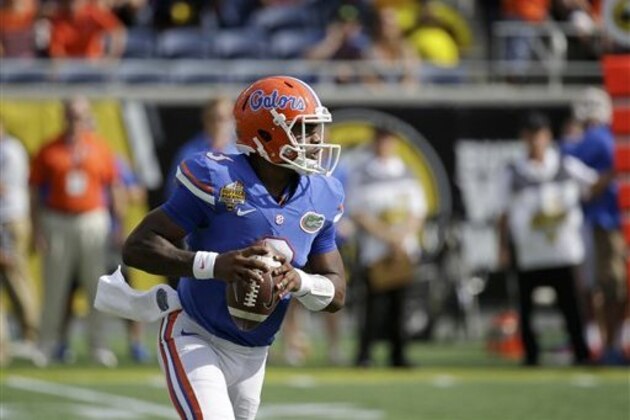 Florida quarterback Treon Harris (3) looks for a receiver against Michigan during the first half of the Citrus Bowl NCAA college football game, Friday, Jan. 1, 2016, in Orlando, Fla. (AP Photo/John Raoux)