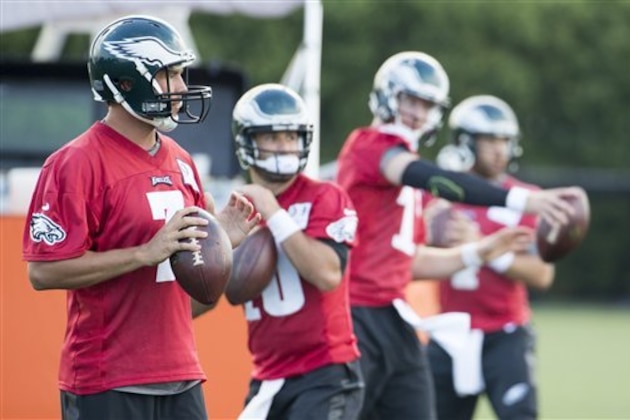 Philadelphia Eagles quarterback Sam Bradford, left, looks on as the quarterbacks warm up during practice at NFL football training camp, Monday, July 25, 2016, in Philadelphia. (AP Photo/Chris Szagola)