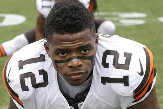 FILE - In this Dec. 21, 2014, file photo, Cleveland Browns' Josh Gordon (12) stretches before an NFL football game against the Carolina Panthers in Charlotte, N.C. A person familiar with the situation tells The Associated Press that Gordon has
