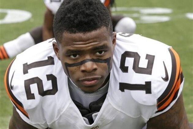 FILE - In this Dec. 21, 2014, file photo, Cleveland Browns' Josh Gordon (12) stretches before an NFL football game against the Carolina Panthers in Charlotte, N.C. Several teams will be missing key players when the NFL season kicks off this weekend.  (AP Photo/Bob Leverone, File)