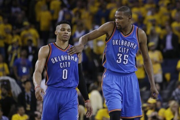 Oklahoma City Thunder's Kevin Durant (35) pats teammate Russell Westbrook (0) on the shoulder as they take a lead over the Golden State Warriors during the second half in Game 1 of the NBA basketball Western Conference finals Monday, May 16, 2016, in Oakland, Calif. Oklahoma City won 108-102. (AP Photo/Marcio Jose Sanchez)