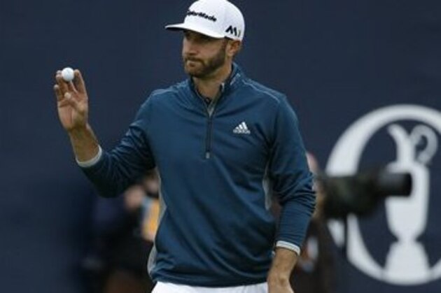 Dustin Johnson of the United States acknowledges the crowd as he walks off the 18th green after completing his second round of the British Open Golf Championships at the Royal Troon Golf Club in Troon, Scotland, Friday, July 15, 2016. (AP Photo/Matt Dunham)