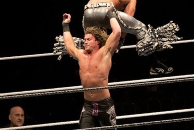 WWE wrestler Dolph Ziggler, below, throws Tyler Breeze during WWE Live India Tour in New Delhi, Friday, Jan. 15, 2016. WWE returned to Indian after a gap of 13 years to entertain their fans. (AP Photo/Manish Swarup)