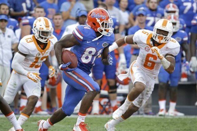 Florida wide receiver Antonio Callaway (81) runs for yardage past Tennessee defensive back Malik Foreman (13) and defensive back Todd Kelly Jr. (6) during the second half of an NCAA college football game, Saturday, Sept. 26, 2015, in Gainesville, Fla. (AP Photo/John Raoux)