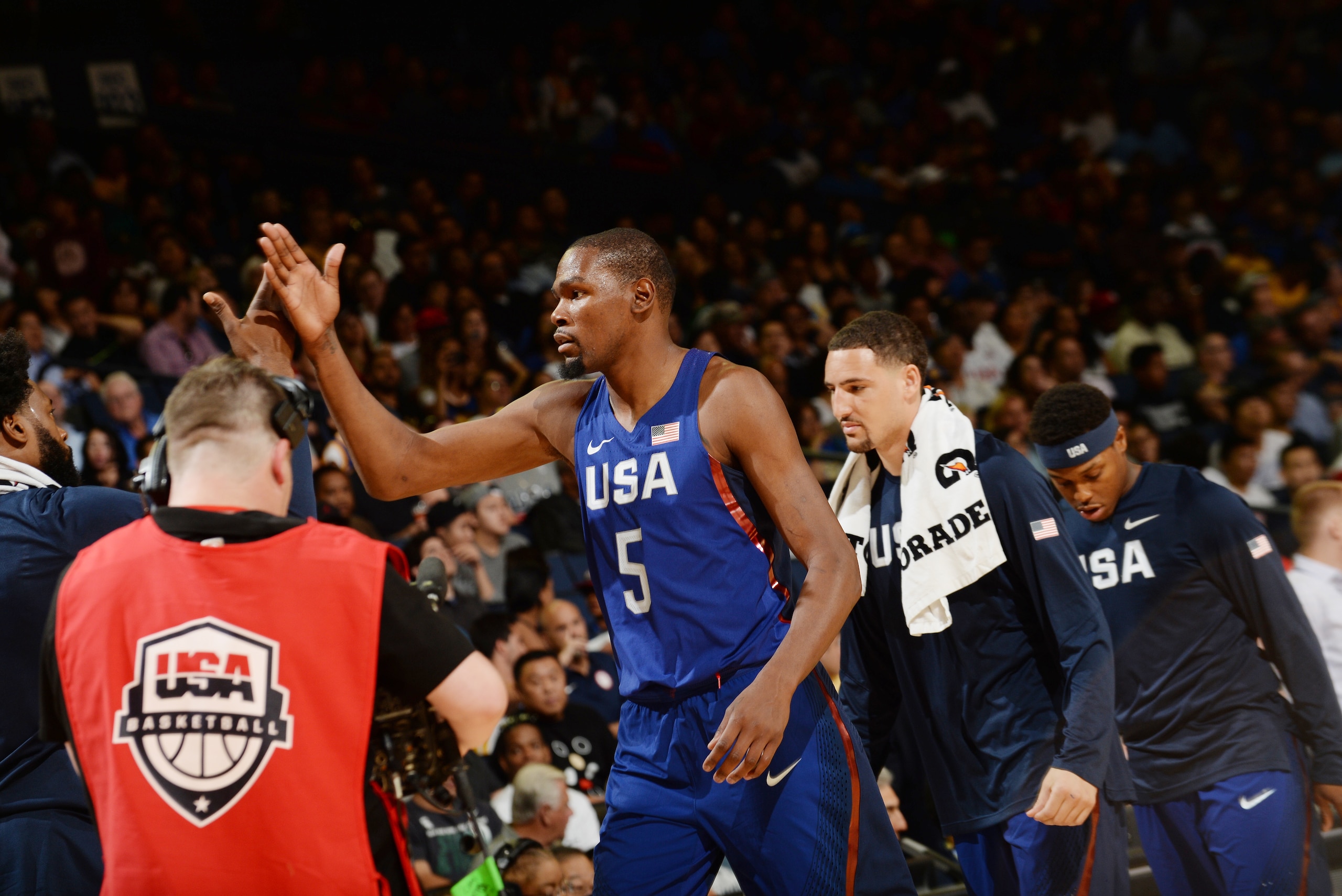 OAKLAND, CA - JULY 26: Kevin Durant #5 of the USA Basketball Men's National Team shakes hands with his teammates during the game against China on July 26, 2016 at ORACLE Arena in Oakland, California. NOTE TO USER: User expressly acknowledges and agrees that, by downloading and/or using this Photograph, user is consenting to the terms and conditions of the Getty Images License Agreement. Mandatory Copyright Notice: Copyright 2016 NBAE (Photo by Noah Graham/NBAE via Getty Images) OAKLAND, CA - JULY 26: Kevin Durant #5 of the USA Basketball Men's National Team shakes hands with his teammates during the game against China on July 26, 2016 at ORACLE Arena in Oakland, California. NOTE TO USER: User expressly acknowledges and agrees that, by downloading and/or using this Photograph, user is consenting to the terms and conditions of the Getty Images License Agreement. Mandatory Copyright Notice: Copyright 2016 NBAE (Photo by Noah Graham/NBAE via Getty Images)