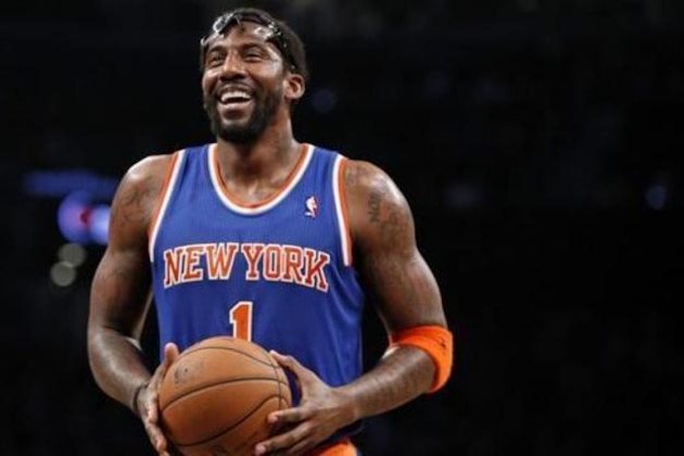 FILE - In this Dec. 5, 2013, file photo, New York Knicks forward Amare Stoudemire smiles before shooting a free throw during the team's NBA basketball game against the Brooklyn Nets in New York. Stoudemire retired Tuesday, July 26, 2016, after signing a contract with the Knicks with much less fanfare than the $100 million deal he inked six years ago to halt the team's downward spiral.