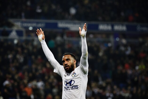 Lyon's French forward Alexandre Lacazette celebrates after scoring a goal during the French L1 football match between Lyon and Nantes at the New Stadium in Decines-Charpieu, central-eastern France, on March 19, 2016. AFP PHOTO / JEFF PACHOUD / AFP / JEFF PACHOUD        (Photo credit should read JEFF PACHOUD/AFP/Getty Images)
