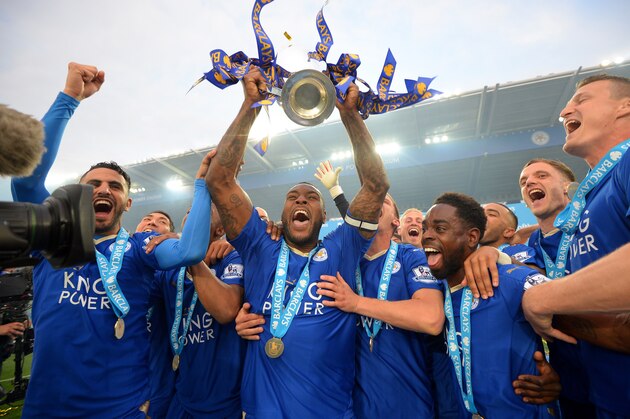 LEICESTER, ENGLAND - MAY 07:  Captain Wes Morgan of Leicester City lifts the Premier League Trophy as players celebrate the season champions after the Barclays Premier League match between Leicester City and Everton at The King Power Stadium on May 7, 2016 in Leicester, United Kingdom.  (Photo by Michael Regan/Getty Images)