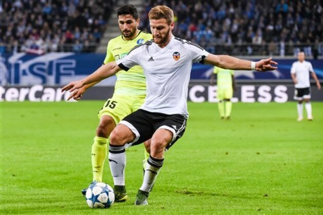 Gent's Gent's Kenny Saief, left, challenges Valencia's Shkodran Mustafi during the Champions League Group H soccer match between KAA Gent and Valencia CF at the Ghelamco Arena in Ghent, Belgium, Wednesday, Nov. 4, 2015. (AP Photo/Geert Vanden Wijngaert)