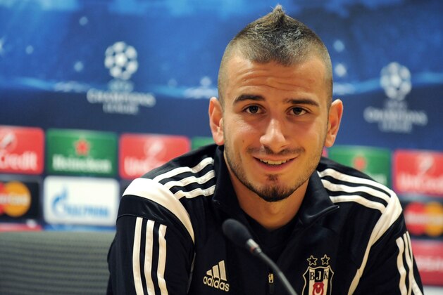 Besiktas' Netherlands-born Turkish midfielder Oguzhan Ozyakup answers questions during a press conference at Arsenal's Emirates Stadium in north London, on August 26, 2014, on the eve of their UEFA Champions League second-leg play-off match against Arsenal. AFP PHOTO/OLLY GREENWOOD        (Photo credit should read OLLY GREENWOOD/AFP/Getty Images)