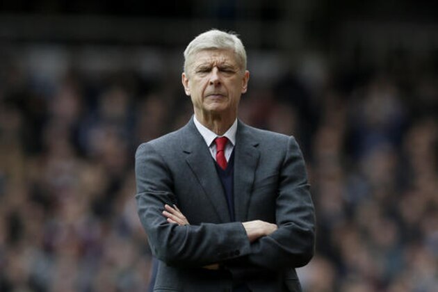 Arsenal manager Arsene Wenger closes his eyes during the English Premier League soccer match between West Ham United and Arsenal at Upton Park stadium in London, Saturday April 9, 2016. (AP Photo/Tim Ireland)