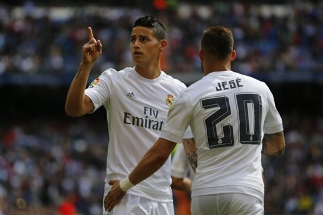 Real Madrid's James Rodriguez, left, celebrates with teammate Jese Rodriguez after scoring the opening goal against Eibar during the Spanish La Liga soccer match between Real Madrid and Eibar at the Santiago Bernabeu stadium in Madrid, Saturday, April 9, 2016. Rodriguez a dn Jese scored once each in Real Madrid's 4-0 victory. (AP Photo/Francisco Seco)
