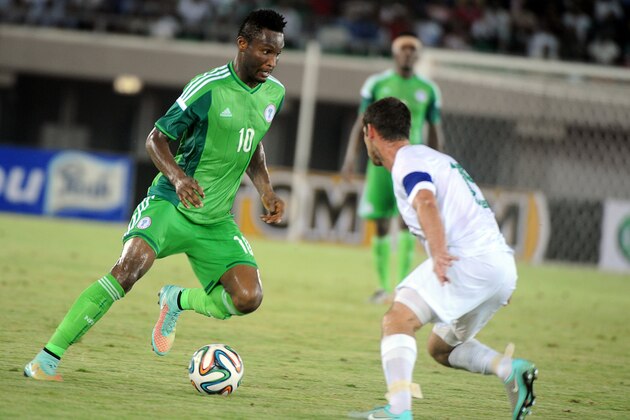Nigeria's midfielder Mikel Obi (L) vies with South Africa's midfielder Dean Furman during the 2015 Africa Cup of Nations qualifying football match between Nigeria and South Africa at Akwa Ibom stadium in Uyo, Nigeria, on November 19, 2014.  AFP PHOTO / PIUS UTOMI EKPEI        (Photo credit should read PIUS UTOMI EKPEI/AFP/Getty Images)