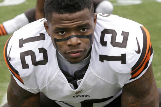 FILE - In this Dec. 21, 2014, file photo, Cleveland Browns' Josh Gordon (12) stretches before an NFL football game against the Carolina Panthers in Charlotte, N.C. Troubled Browns wide receiver Josh Gordon has been reinstated to the NFL on a conditional basis. Commissioner Roger Goodell informed Gordon on Monday, July 25, 2016,  that he can rejoin the team during training camp and will be allowed to participate in meetings and conditioning work. The league said once Gordon meets clinical requirements, he will be allowed to participate in all preseason activities, including practices and games. (AP Photo/Bob Leverone, File)