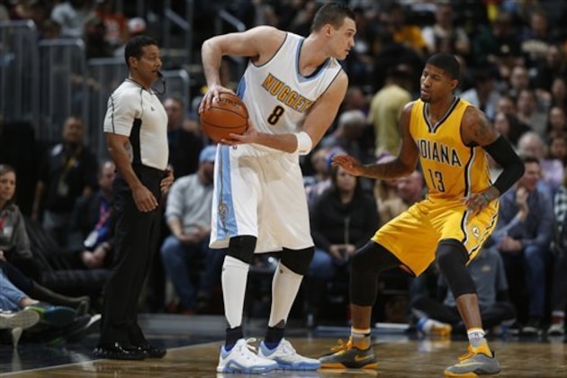 Denver Nuggets forward Danilo Gallinari (8), left, looks to pass the ball as Indiana Pacers forward Paul George (13) defends during the second half of an NBA basketball game Sunday, Jan. 17, 2016, in Denver. The Nuggets won 129-126. (AP Photo/David Zalubowski)