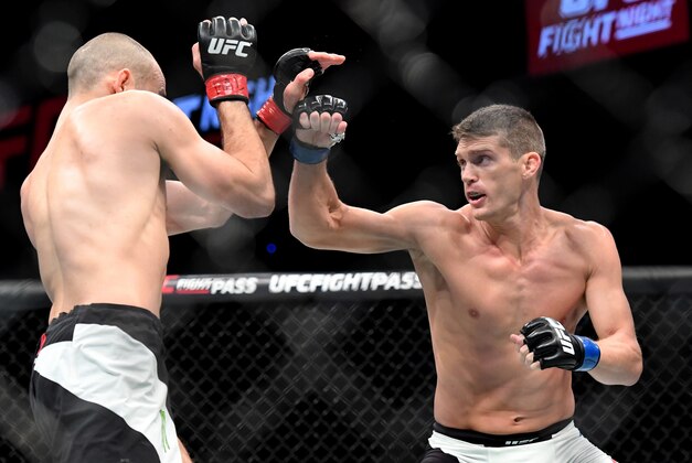 Jun 18, 2016; Ottawa, Ontario, Canada; Stephen Thompson (blue gloves) fights Rory MacDonald (red gloves) during UFC Fight Night at TD Place Arena. Mandatory Credit: Marc DesRosiers-USA TODAY Sports