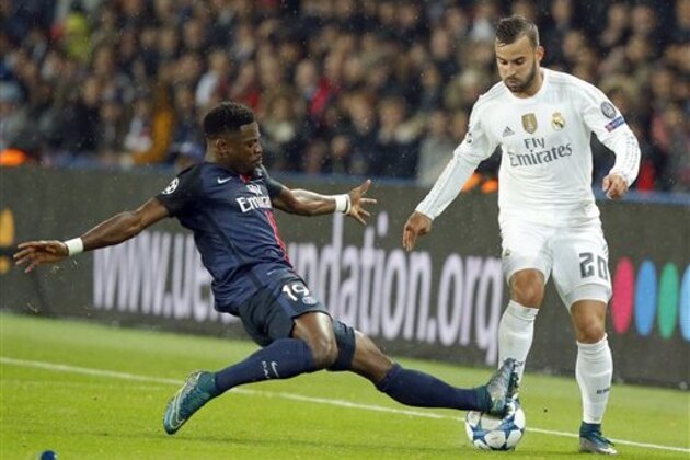 Real Madrid's Jese Rodriguez, right, is tackled by PSG's Serge Aurier during the Champions League group A soccer match between Paris St Germain and Real Madrid at the Parc des Princes stadium in Paris, Wednesday, Oct. 21, 2015. (AP Photo/Michel Euler)