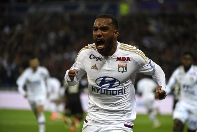 Lyon's French forward Alexandre Lacazette celebrates after scoring during the French L1 football match Olympique Lyonnais and OGC Nice on April 15, 2016, at the New Stadium in Decines-Charpieu near Lyon, southeastern France.      AFP PHOTO/PHILIPPE DESMAZES / AFP / PHILIPPE DESMAZES        (Photo credit should read PHILIPPE DESMAZES/AFP/Getty Images)