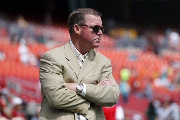 In this photo taken Sept. 13, 2015, Washington Redskins general manager Scot McCloughan walks on the field before an NFL football game against the Miami Dolphins, in Landover, Md. After seeing their team unravel following a disputed penalty call in a 28-point loss this season, a couple of veterans on the Redskins, safety Dashon Goldson and nose tackle Terrance “Pot Roast” Knighton thought a players-only meeting would be a good idea.  (AP Photo/Patrick Semansky)