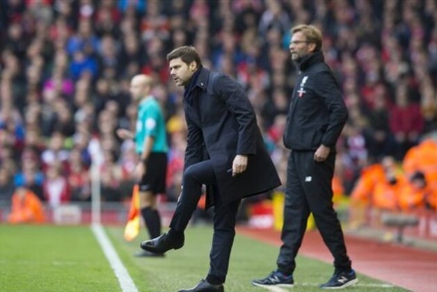 Tottenham's manager Mauricio Pochettino, centre, stands alongside Liverpool's manager Juergen Klopp during the English Premier League soccer match between Liverpool and Tottenham Hotspur at Anfield Stadium, Liverpool, England, Saturday, April 2, 2016. (AP Photo/Jon Super)