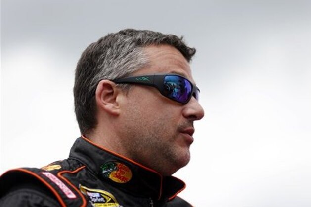 NASCAR driver Tony Stewart (14) waits for the race to being before the NASCAR Talladega auto race driver introductions at Talladega Superspeedway, Sunday, May 1, 2016, in Talladega, Ala. (AP Photo/Brynn Anderson)