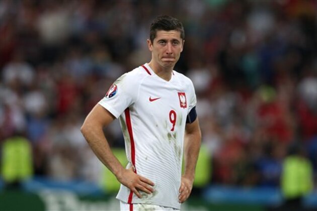 Poland's Robert Lewandowski reacts at the end of the Euro 2016 quarterfinal soccer match between Poland and Portugal, at the Velodrome stadium in Marseille, France, Thursday, June 30, 2016. Portugal defeated Poland 5-3 in a penalty shootout after the game ended tied 1-1. (AP Photo/Thanassis Stavrakis)