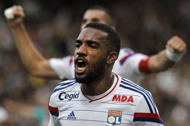 Lyon's Alexandre Lacazette celebrates after he scored his second goal against Lille during their French League One soccer match in Lyon, central France, Sunday, Oct. 5, 2014. (AP Photo/Laurent Cipriani)