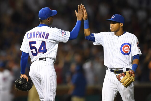 Jul 27, 2016; Chicago, IL, USA; Chicago Cubs relief pitcher Aroldis Chapman (left) and shortstop Addison Russell (right) celebrate their victory over the Chicago White Sox at Wrigley Field. The Cubs won 8-1. Mandatory Credit: Patrick Gorski-USA TODAY Sports