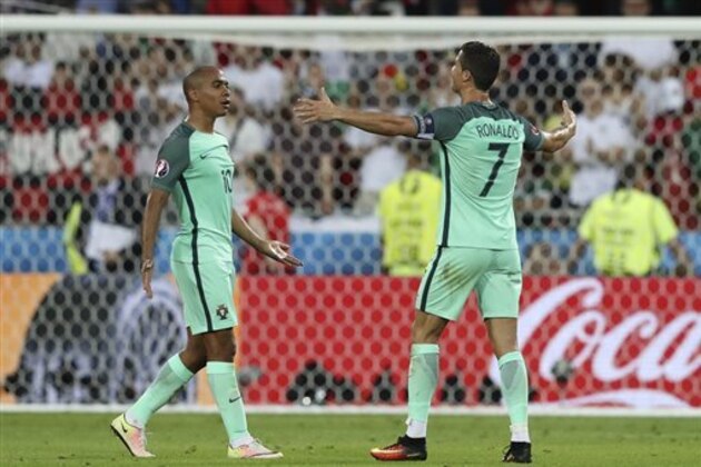 Portugal's Cristiano Ronaldo, right, celebrates with Portugal's Joao Mario, left,  at the end of  the Euro 2016 semifinal soccer match between Portugal and Wales, at the Grand Stade in Decines-­Charpieu, near Lyon, France, Wednesday, July 6, 2016. Portugal won 2-0. (AP Photo/Thanassis Stavrakis)