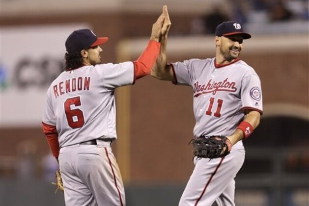 Washington Nationals third baseman Anthony Rendon (6) and first baseman Ryan Zimmerman (11) celebrate after a 4-1 win over the San Francisco Giants during  baseball game Friday, July 29, 2016, in San Francisco. (AP Photo/Marcio Jose Sanchez)