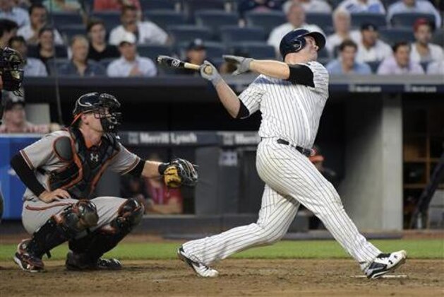 New York Yankees' Brian McCann, right, hits a sacrifice fly scoring Brett Grdner as Baltimore Orioles catcher Matt Wieters looks on during the third inning of a baseball game Monday, July 18, 2016, at Yankee Stadium in New York. The Yankees won 2-1. (AP Photo/Bill Kostroun)