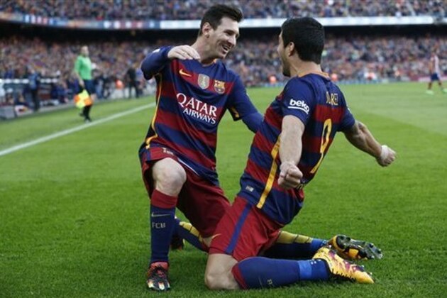 FC Barcelona's Luis Suarez, right, reacts after scoring with his teammate Lionel Messi against Atletico Madrid during a Spanish La Liga soccer match at the Camp Nou stadium in Barcelona, Spain, Saturday, Jan. 30, 2016. (AP Photo/Manu Fernandez)