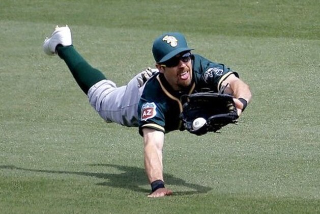 Oakland A's BIlly Burns can't make the catch on a base hit by Chicago Cubs' Miguel Montero during the second inning of a spring training baseball game, Tuesday, March 29, 2016, in Mesa, Ariz. (AP Photo/Matt York)
