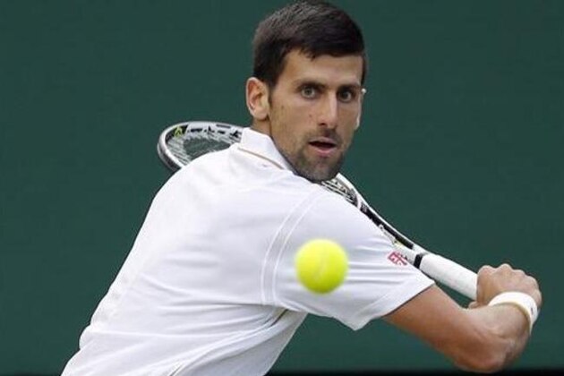 Novak Djokovic of Serbia returns to Sam Querrey of the U.S during their men's singles match on day six of the Wimbledon Tennis Championships in London, Saturday, July 2, 2016. (AP Photo/Alastair Grant)