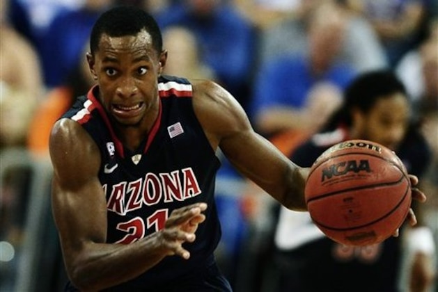 Arizona's Kyle Fogg (21) drives the ball during an NCAA college basketball game against Florida in Gainesville, Fla., on Wednesday, Dec. 7, 2011. Florida won 78-72. (AP Photo/Phil Sandlin)