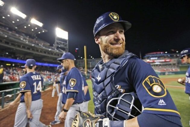 Milwaukee Brewers catcher Jonathan Lucroy smiles as he leaves the field after celebrating with his teammates, after a baseball game against the Washington Nationals at Nationals Park, Tuesday, July 5, 2016, in Washington. The Brewers won 5-2. (AP Photo/Alex Brandon)